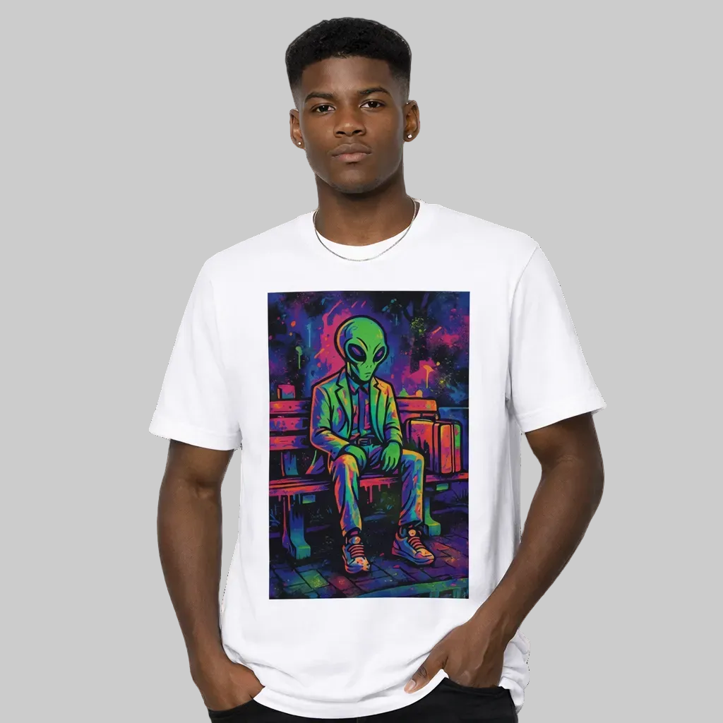 Person wearing a white t-shirt with a colorful alien graphic design on a white background