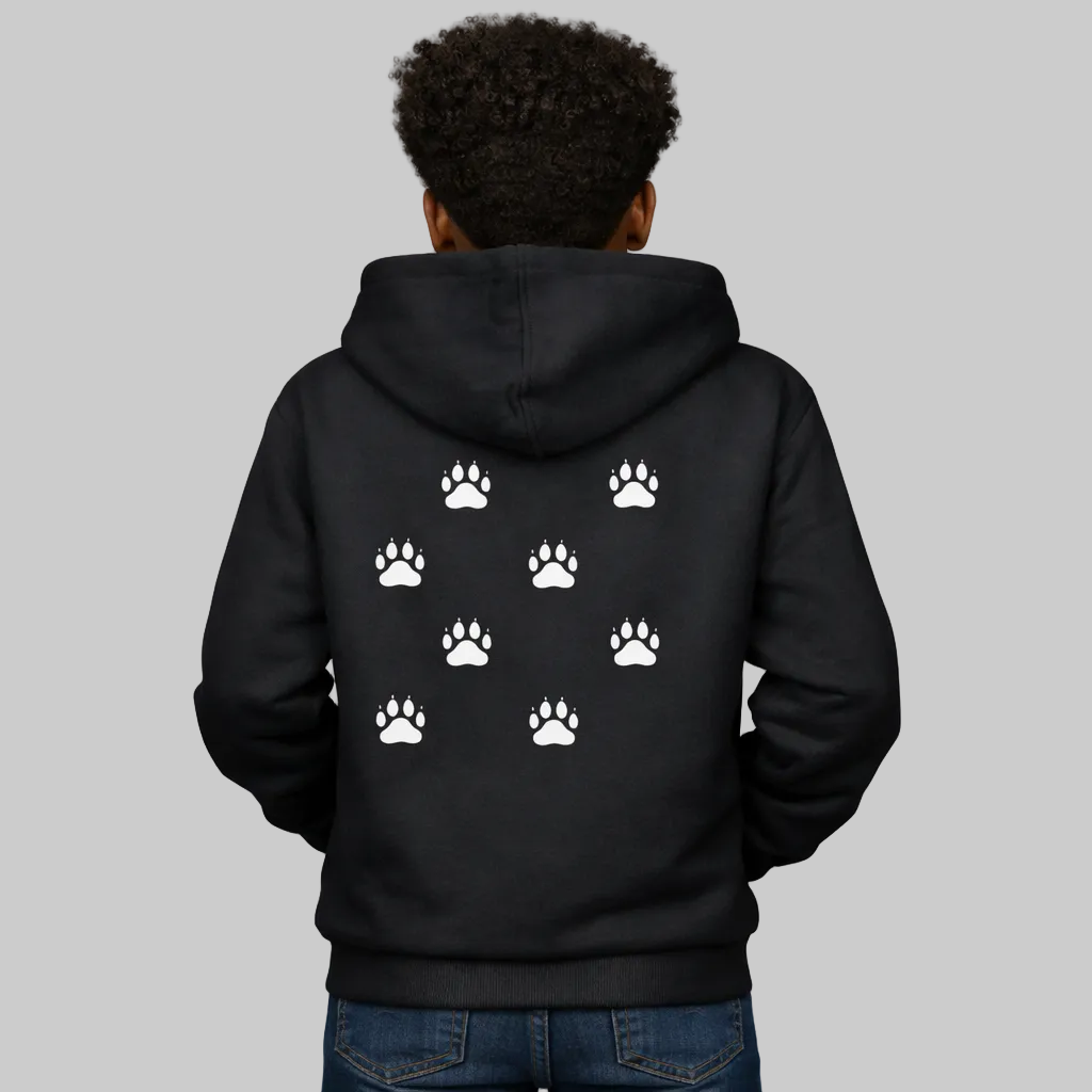 Person wearing a black hoodie with white paw prints on the back, standing against a white background