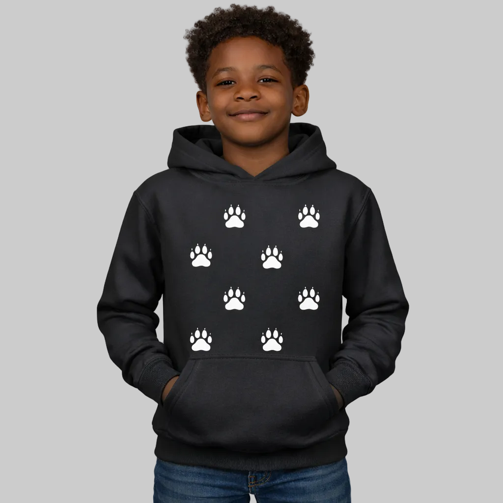 Child wearing a black hoodie with white paw prints on a white background