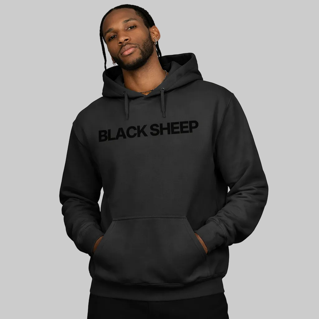 Person wearing a black hoodie with 'BLACK SHEEP' text on a white background