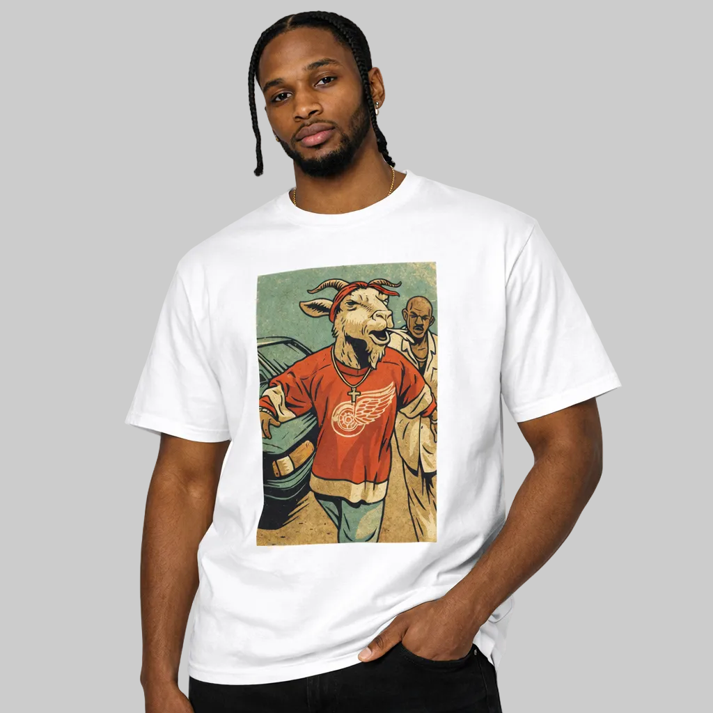 Man wearing a white t-shirt with a graphic design of a goat in a red shirt and jeans.