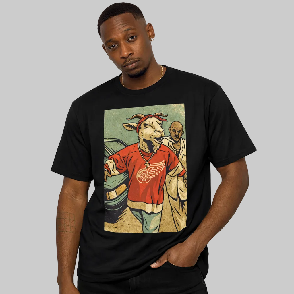 Man wearing a black t-shirt with a graphic design of a goat in a red shirt and sunglasses.