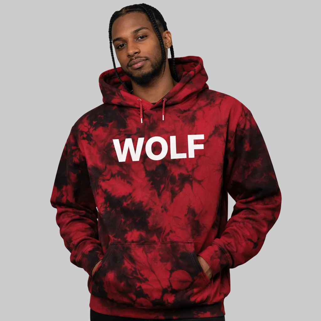 Person wearing a red and black tie-dye hoodie with 'WOLF' text on a white background