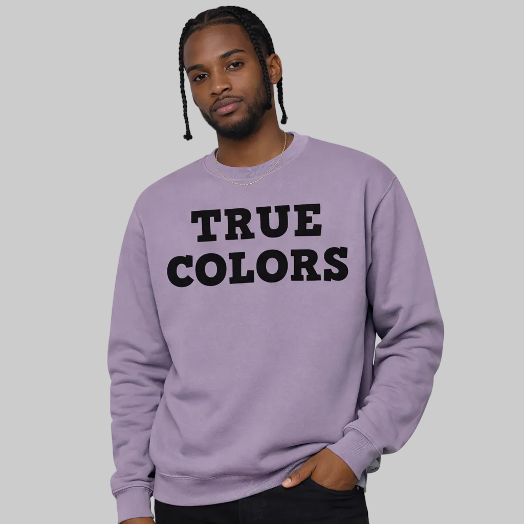 Person wearing a purple sweatshirt with 'TRUE COLORS' text on a white background