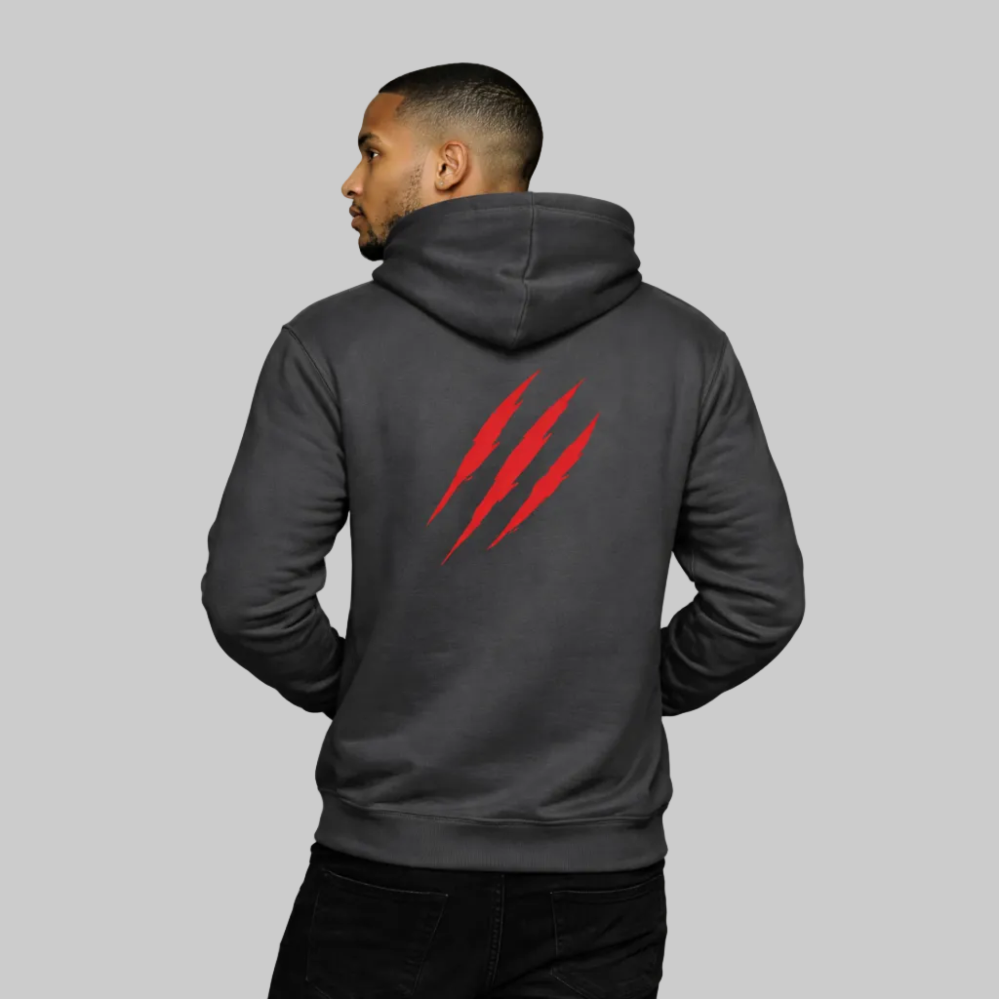 Person wearing a dark gray hoodie with a red logo on the back against a white background