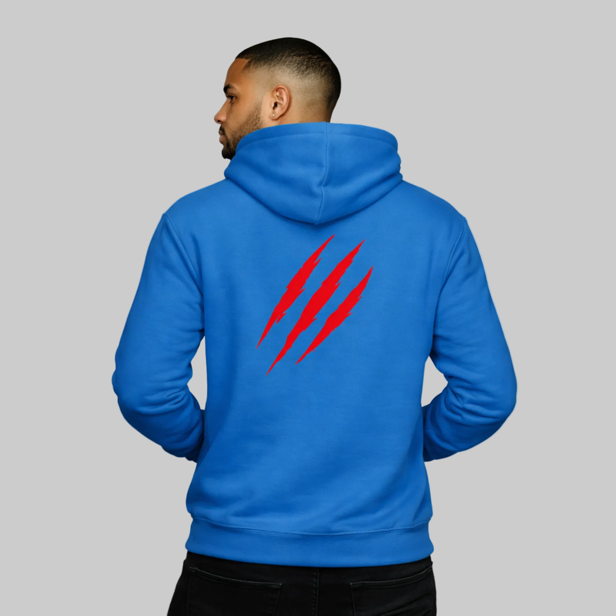 Person wearing a blue hoodie with red designs on the back against a white background